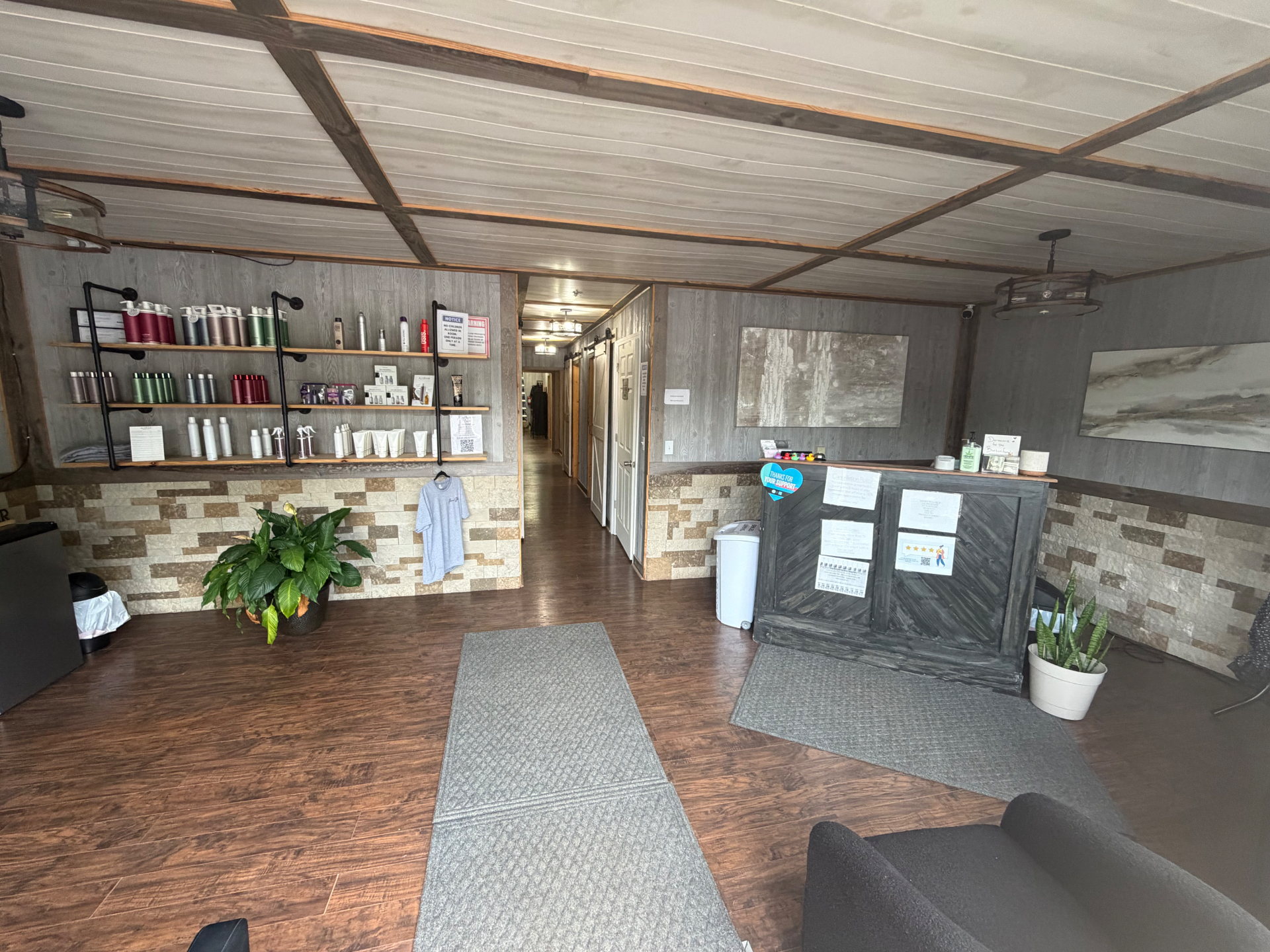 Premiere Hair & Co. salon interior with rustic wood walls and stone reception desk