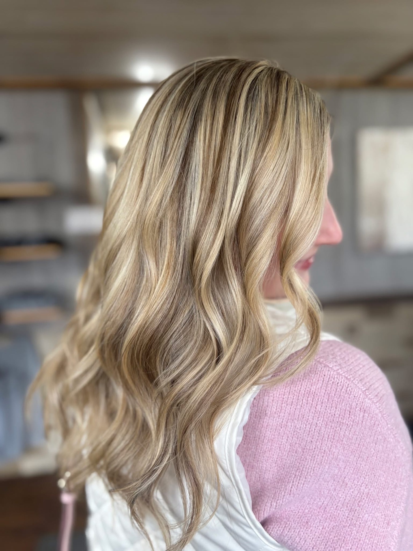 Blonde balayage with lived-in dimension and soft waves